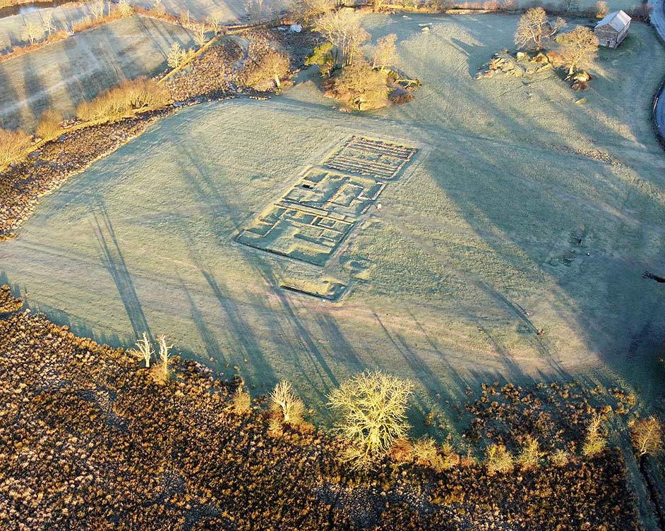 Aerial view of the remains of Ambleside Roman Fort, looking north-west. The ouline of the fort is clearly visible as a raised rectangular platform