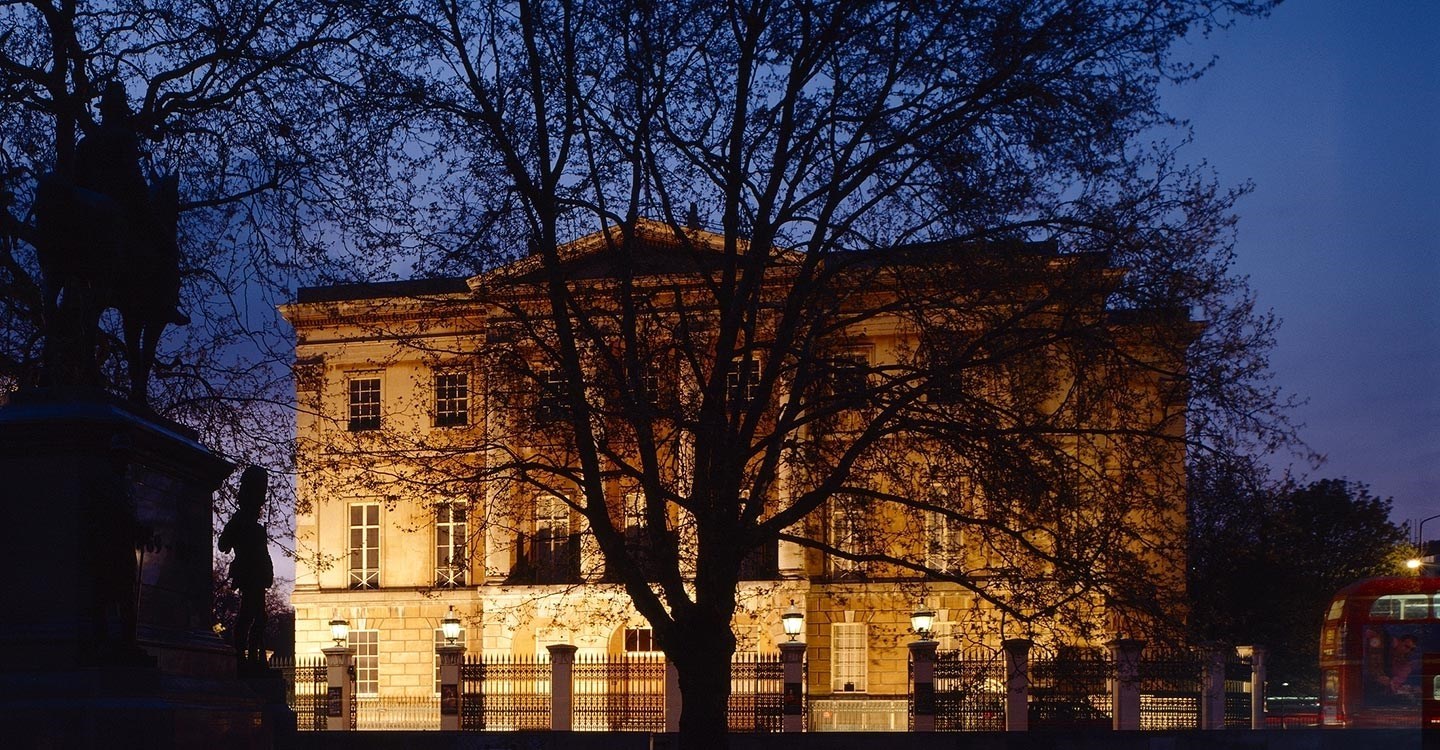 View from the south east of Apsley House floodlit at night with silhoette of the Wellington Statue to the left