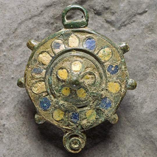 An enamelled bronze disc brooch found at Birdoswald