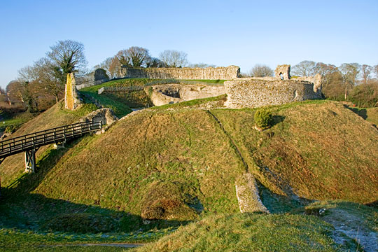The inner bailey at Castle Acre ruined walls on the raised mound approached by a wooden bridge