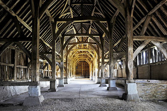 The interior of the great barn, looking towards the north end, the massive square profile posts supported on stone stanchions