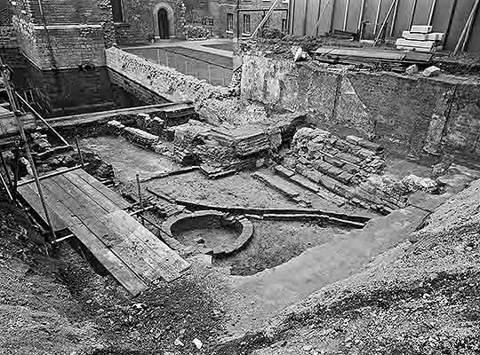 Black and white photograph from November 1962 taken during excavation of the Jewel Tower moat, filled with water at that time
