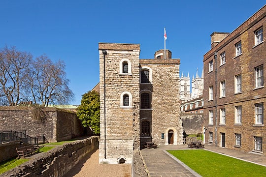 The Jewel Tower from the east, the towers of Westminster Abbey rising behind buildings in the background
