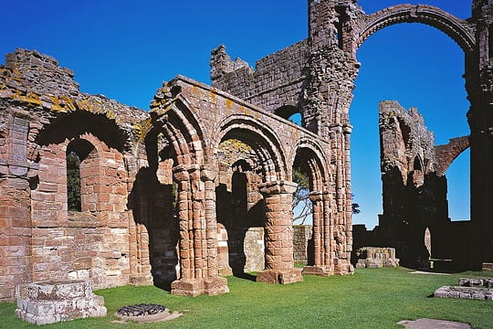 The north nave arcade of the church set in well tended lawn at Lindisfarne Priory