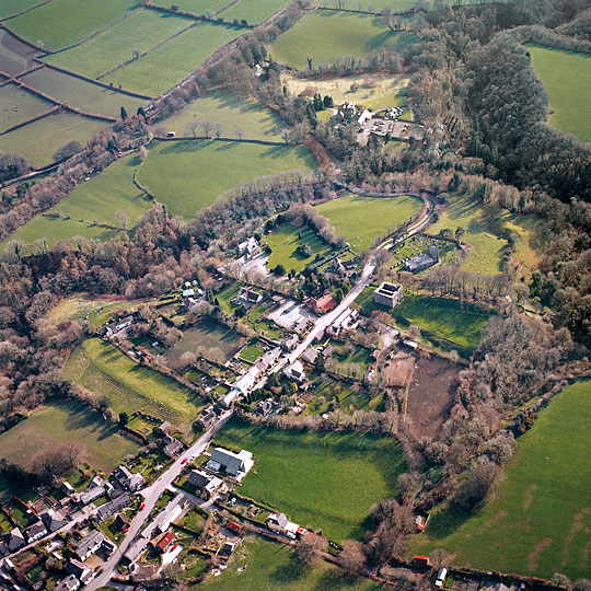 Aerial photograph of Lydford from the north-east, the narrow road running through the village past the tower