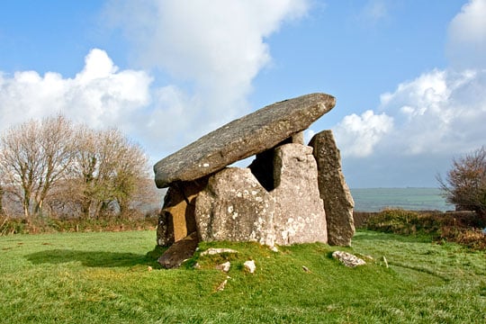 Trethevy Quoit stands impressively in its small pasture field with rolling hills beyond