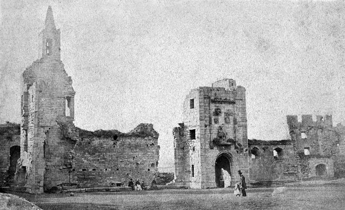 A photograph of the hall range, with visitors to Warkworth Castle and Hermitage, in the late 19th century