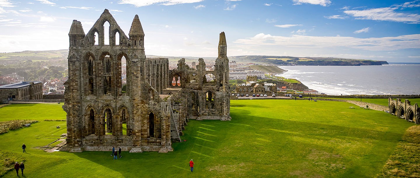 An aerial view of Whitby Abbey ruins with the town and coast in the background An aerial view of Whitby Abbey ruins with the town and coast in the background