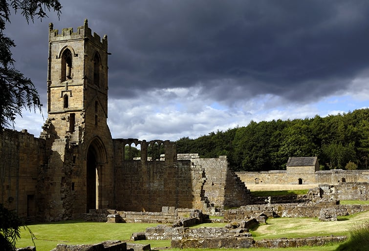 resize-MOUNT-GRACE-PRIORY-Reconstructed-monks-cell-and-church-tower-from-the-south-west-of-the-inner-court-stormy-sky.jpg