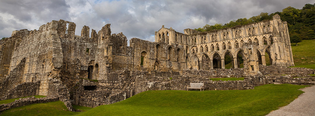An impressive ruined abbey beneath cloudy skies