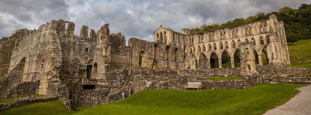 An impressive ruined abbey beneath cloudy skies An impressive ruined abbey beneath cloudy skies