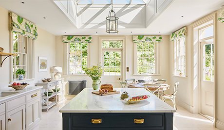 The kitchen is complete with white quartz counters and an electric range cooker.