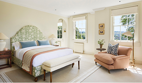 The master bedroom features an elegant super king sized bed with a vintage silhouette. 