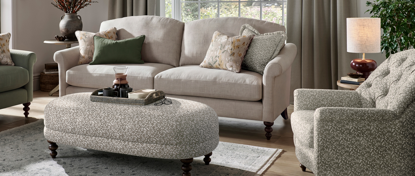A view of the Branded Furniture Company Clover Collection footstall and fabric sofas in a living room.