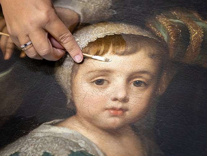Close-up of the cleaning of a large oil painting from the collection at Marble Hill, London Close-up of the cleaning of a large oil painting from the collection at Marble Hill, London