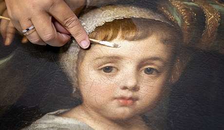 Close-up of the cleaning of a large oil painting from the collection at Marble Hill, London Close-up of the cleaning of a large oil painting from the collection at Marble Hill, London