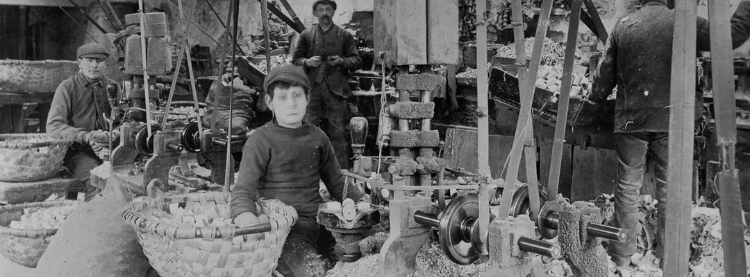 A boy working the automatic boring machine at Stott Park in about 1906