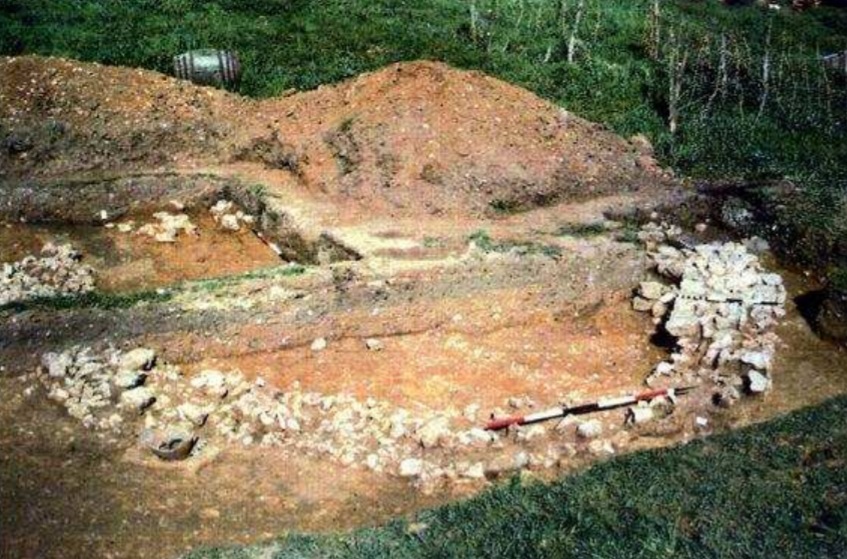 The remains of the mausoleum at Frog Farm being excavated. There are stone foundations showing half of an octagonal room. 