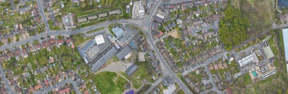 An aerial view of Wilmington showing roads, buildings and small green spaces. 