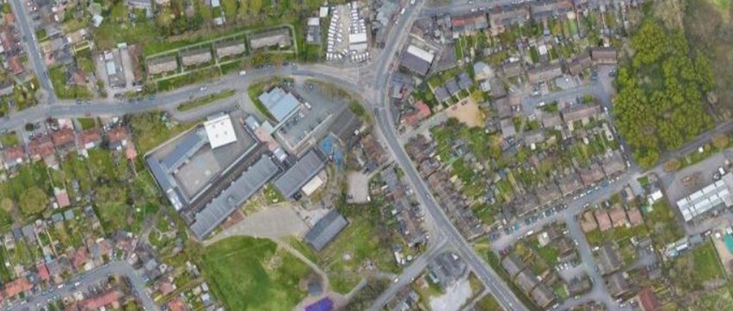 An aerial view of Wilmington showing roads, buildings and small green spaces.