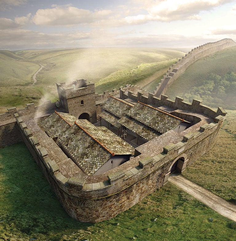 A crenellated square stone wall encasing tiled roof buildings and a tall tower with crenellations. This milecastle is situated on Hadrian Wall (a crenellated stone wall) which can be seen disappearing into the distance towards the right-hand side of the image.