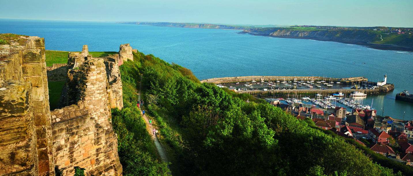 Hillside view of Scarborough castle looking out onto the harbour 