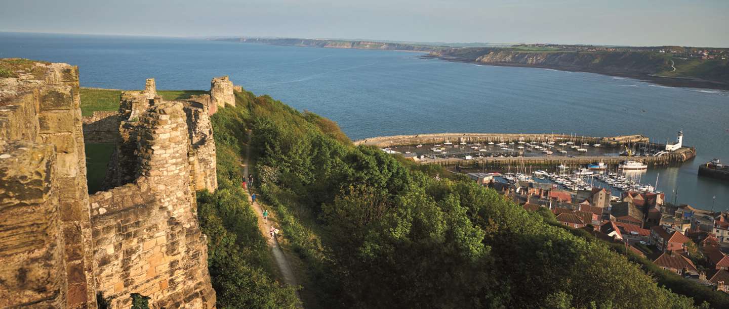 Hillside view of Scarborough castle looking out onto the harbour 