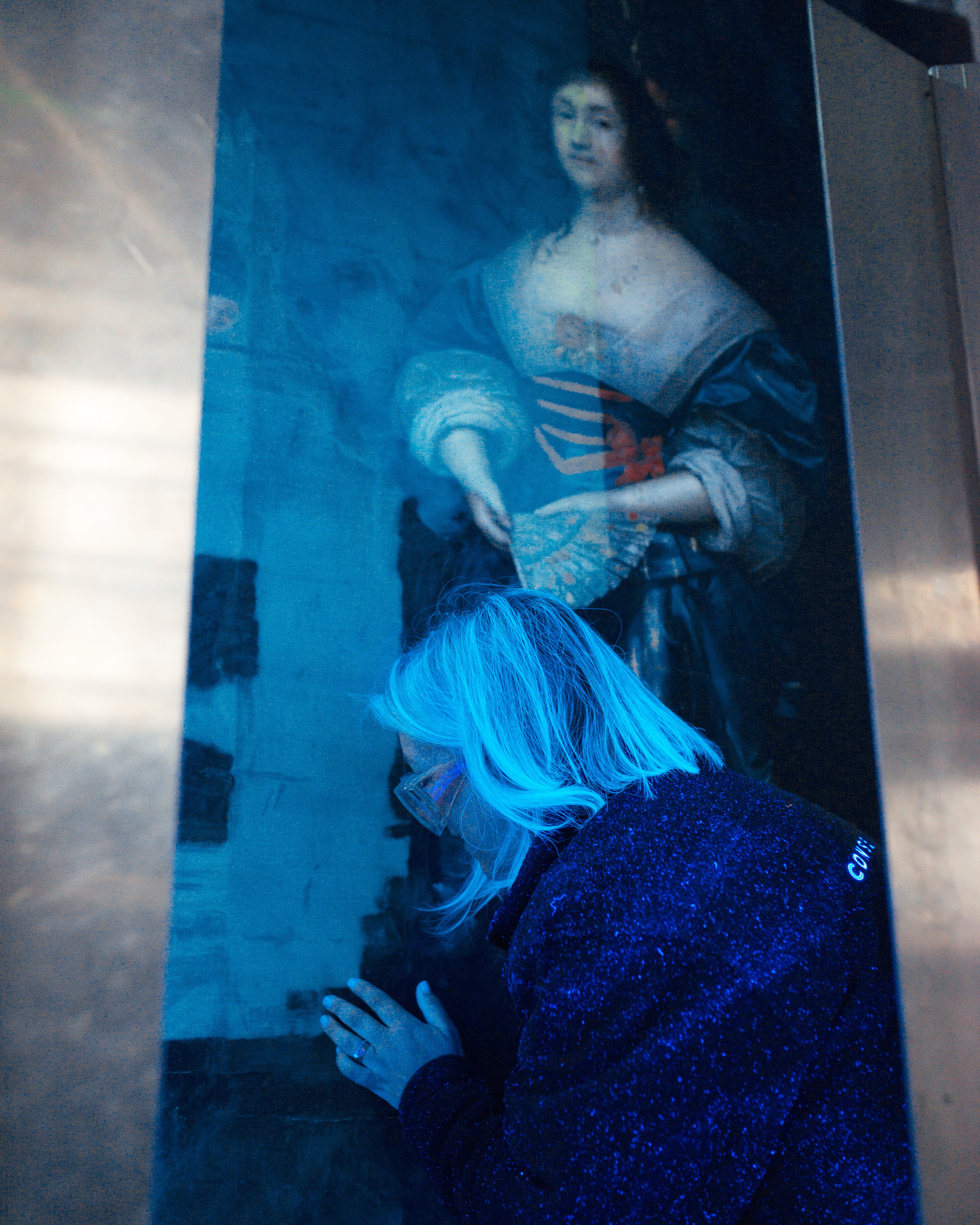 Image: Conservator looking at a painting under ultraviolet light