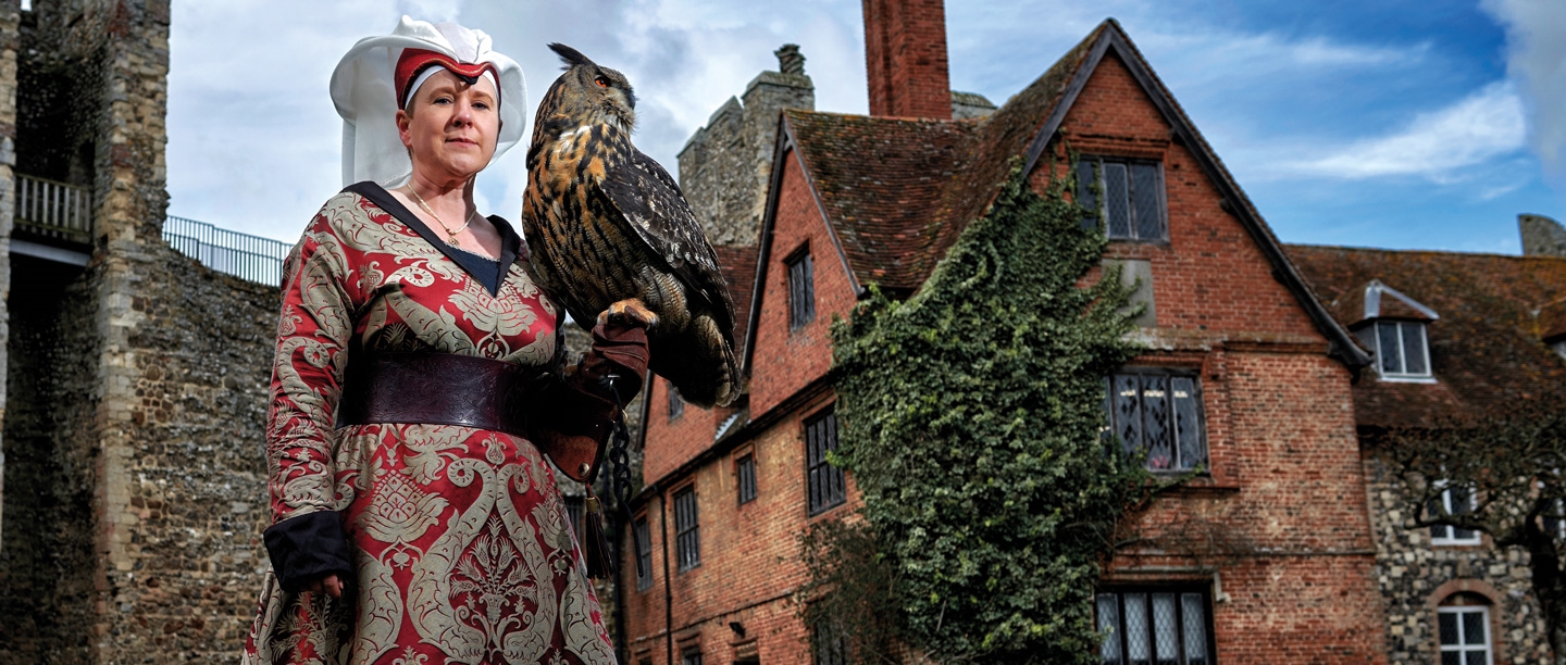 Image: Emma Raphael holding a bird of prey