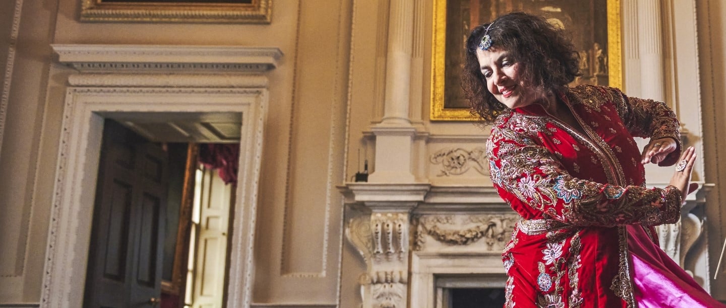 Image: A person in a red dress dances at Marble Hill in London