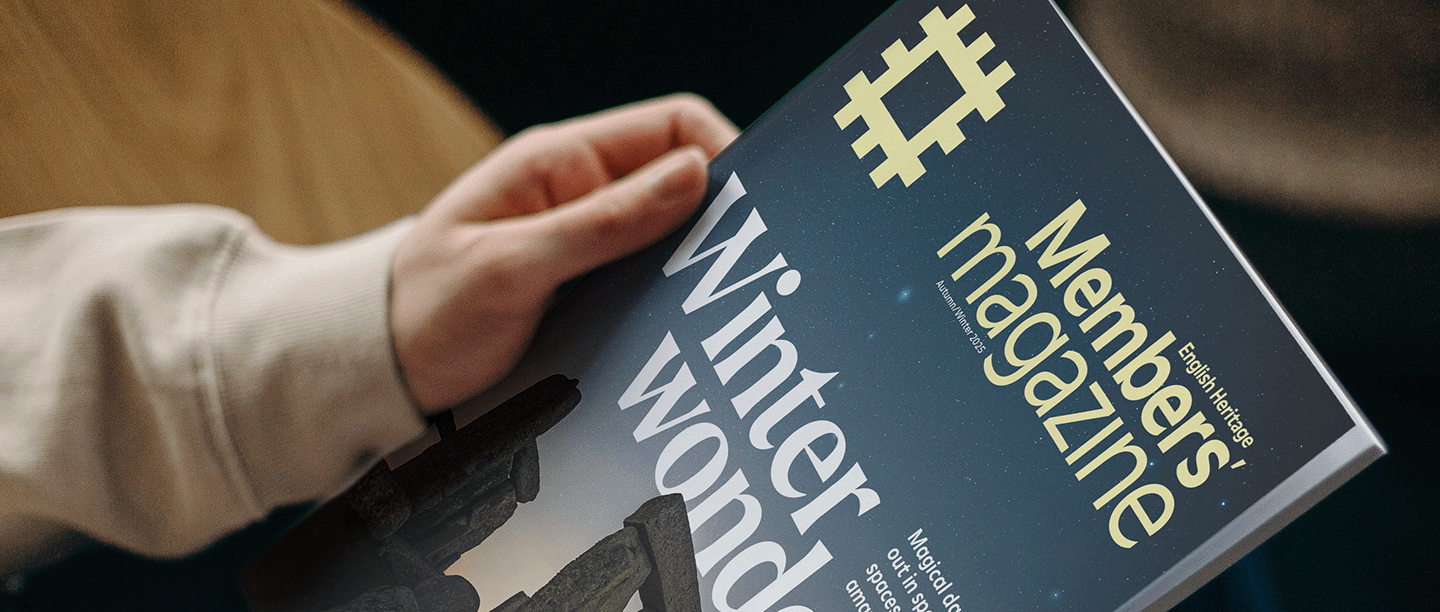 Photo of someone holding the Autumn/Winter 2025 issue of the English Heritage members' magazine, featuring an image of Stonehenge on the front cover, on their lap