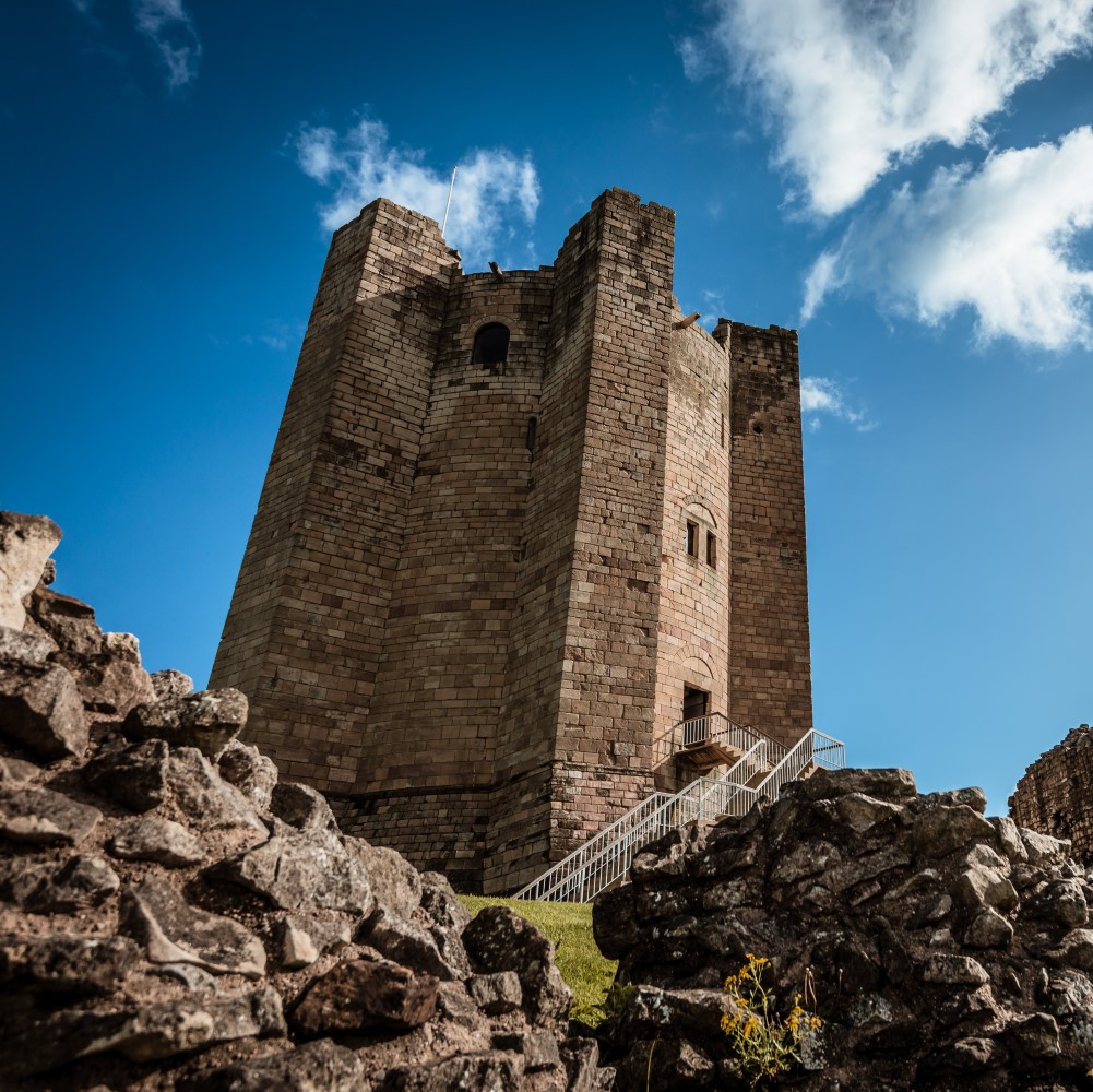 Photo of the keep of Conisbrough Castle on a sunny day from below
