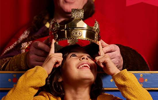 Image: child has crown placed on head at Dover Castle