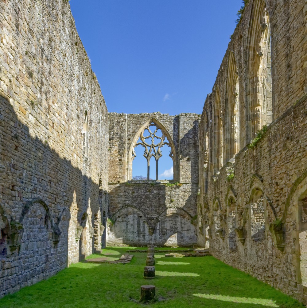 Photo looking down the ruins of Easby Abbey on a sunny day
