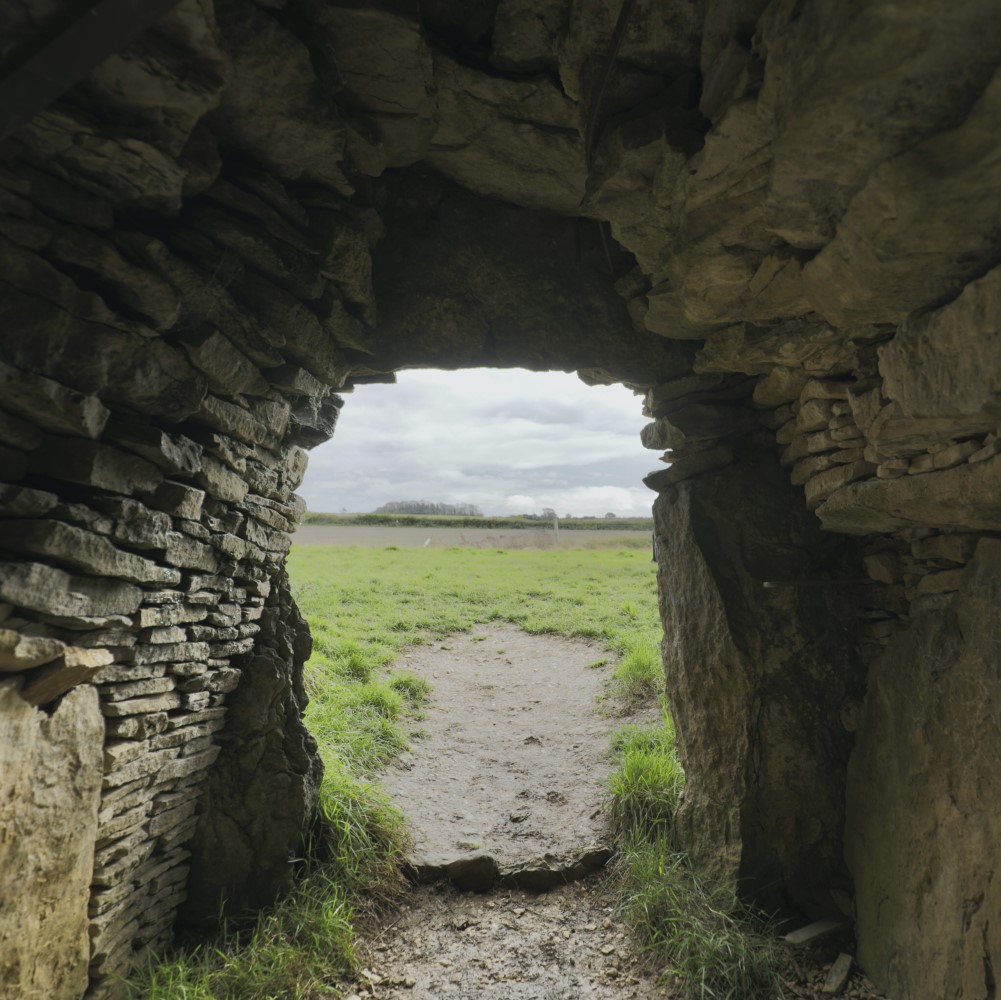 Photo looking out of the doorway of Stoney Littleton Long Barrow on a cloudy day