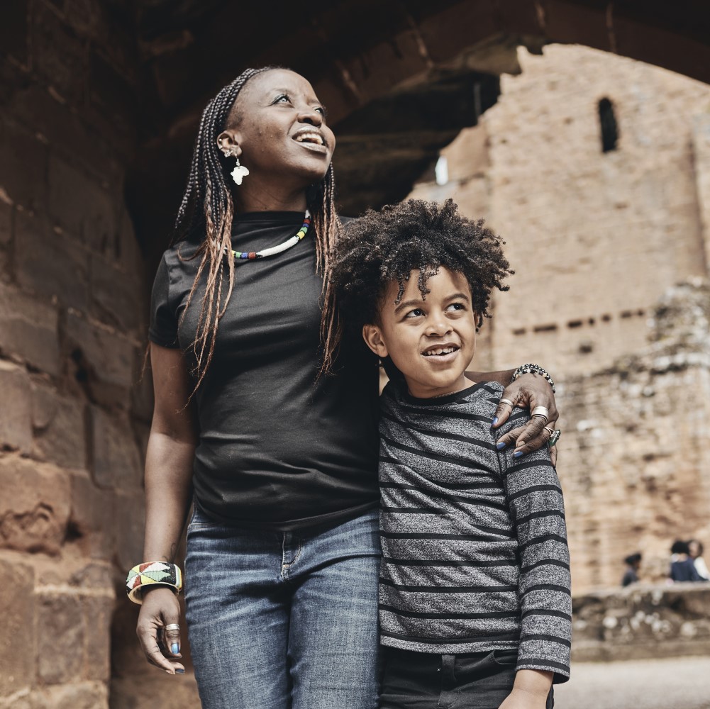 Photo of an adult and a child walking through an archway at Kenilworth Castle