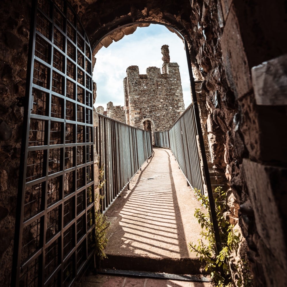 Photo looking through a stone doorway towards Framlingham Castle on a sunny day