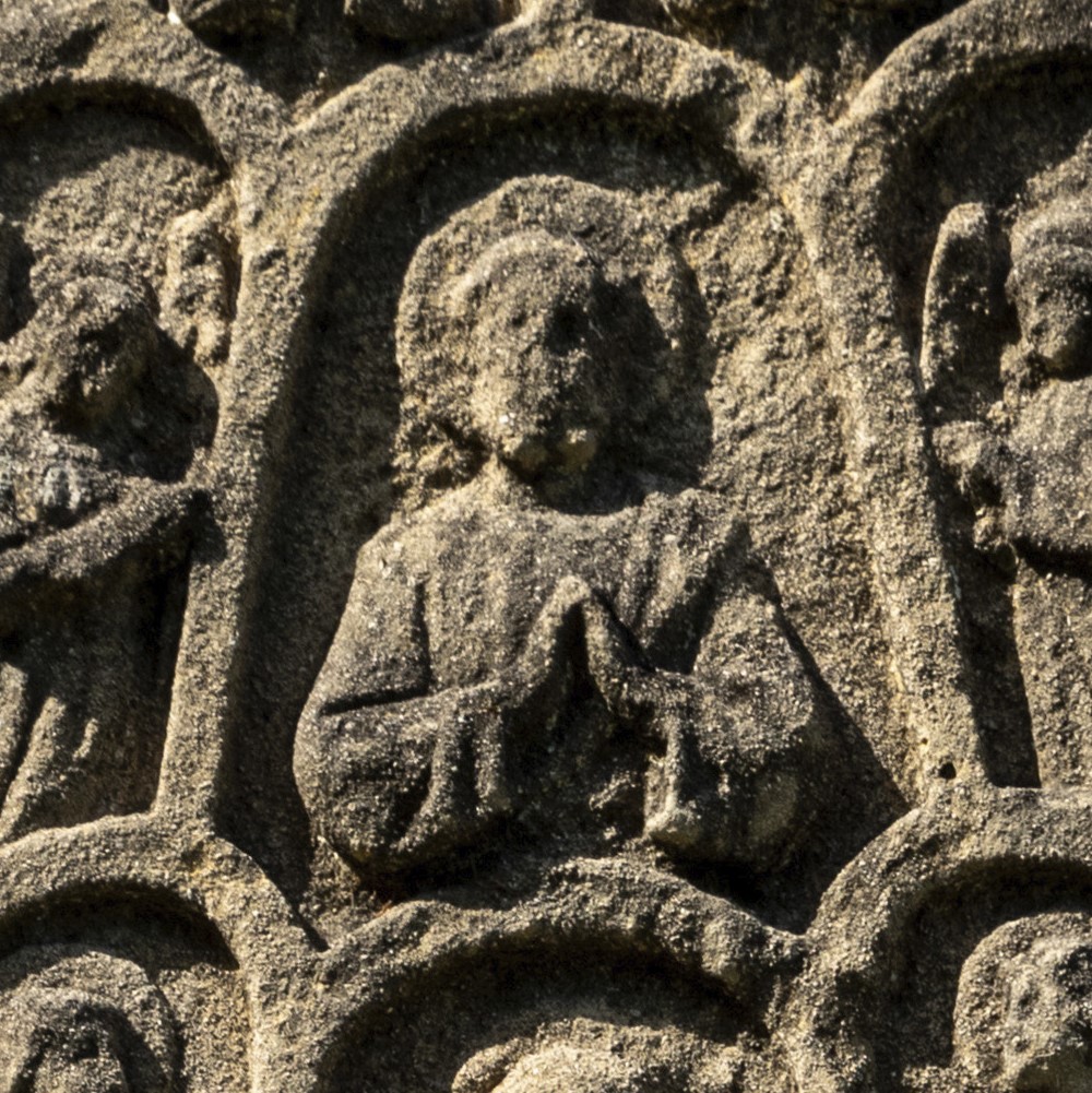 Close-up photo of a medieval stone carving of St Augustine