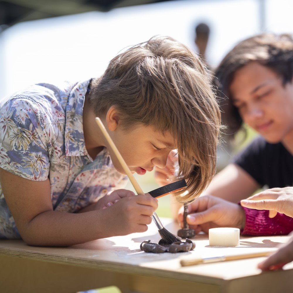 Photo of two children painting small objects