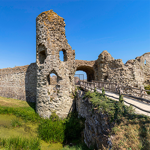 Photo of the remains of the gatehouse at Pevensey Castle on a sunny day