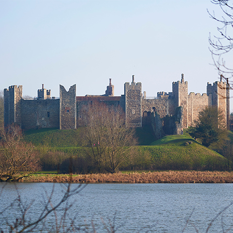 Photo of the walls of Framlingham Castle, seen from across the water
