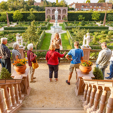 Image: tour guide with visitors in the Elizabethan Garden at Kenilworth Castle