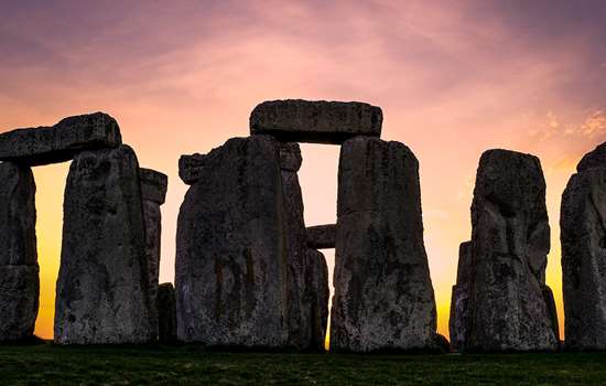 Image: sun setting behind Stonehenge