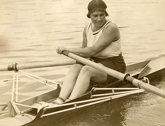 Monochrome photograph of oarswoman Amy Gentry in her boat on the river