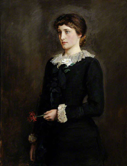 Image of Lillie Langtry in a black dress against a dark background, with a lily at her collar and another in her hand