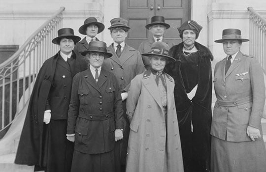 Black and white photograph of eight women in military uniforms or smart clothes standing on the steps - Maud McCarthy is centre front Black and white photograph of eight women in military uniforms or smart clothes standing on the steps - Maud McCarthy is centre front