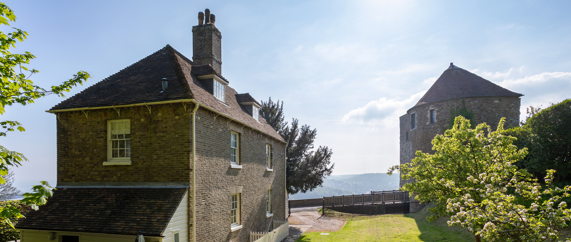A view of the exterior of The Sergeant Major's House holiday cottage at Dover Castle on a sunny day.