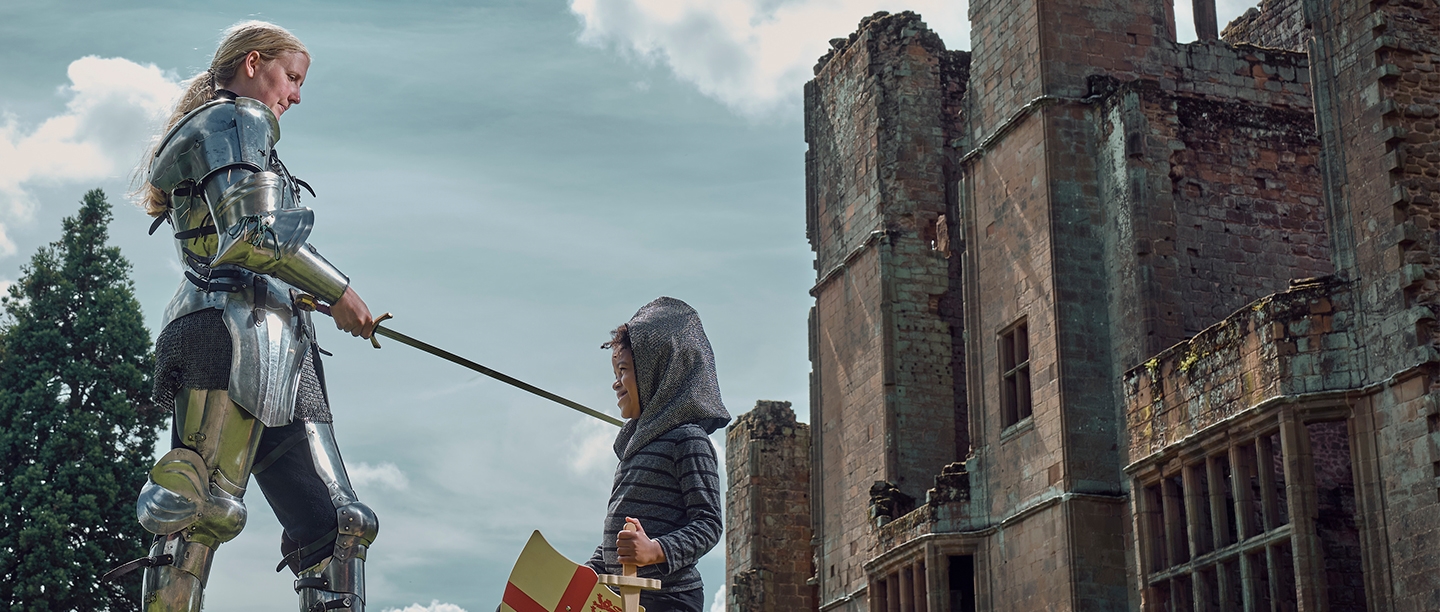 Image: a female knight knights a small boy