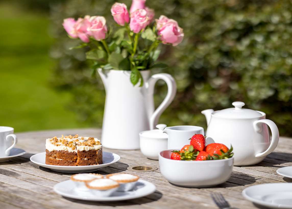 Image: Strawberries, tea and cake on a table Image: Strawberries, tea and cake on a table
