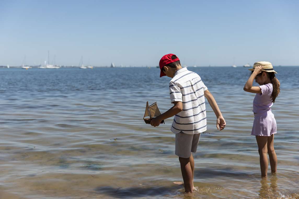 Image: Children paddling in the sea at Osborne Image: Children paddling in the sea at Osborne